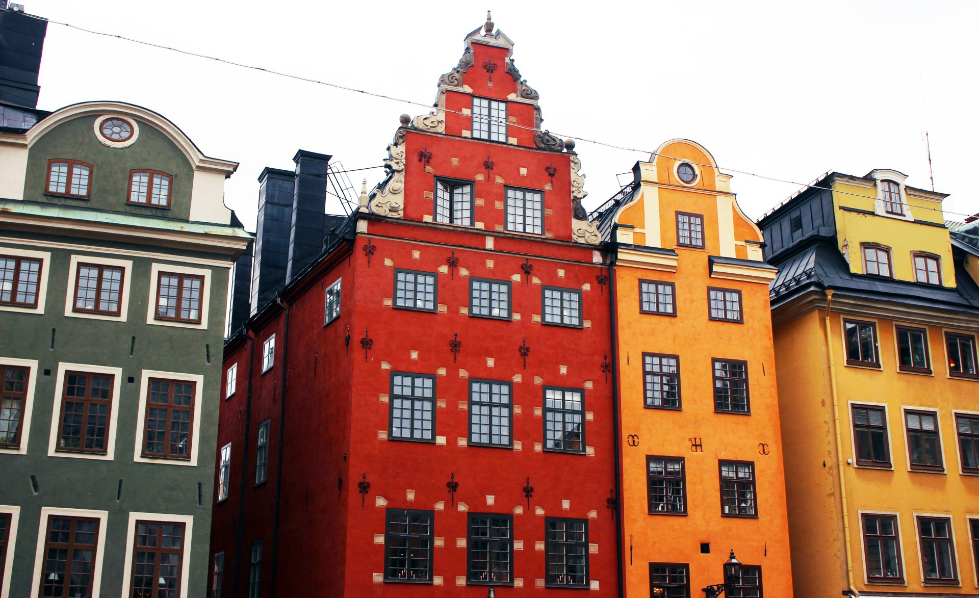 a row of colorful buildings with a clock on top